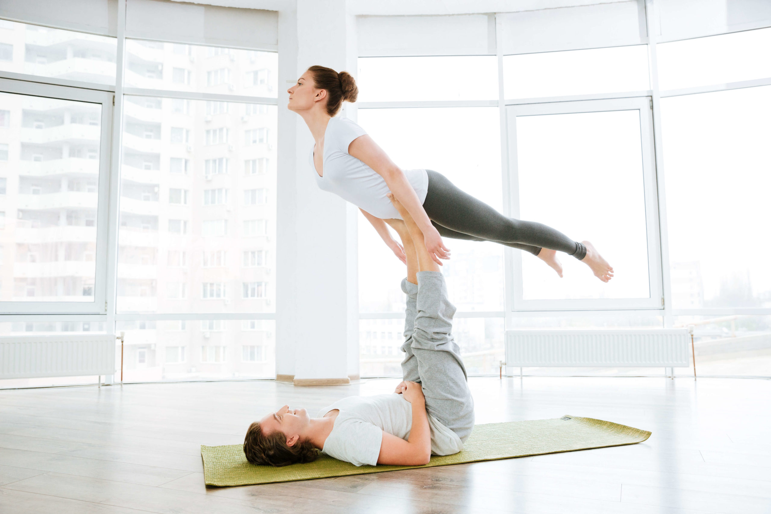 Couple going acro yoga
