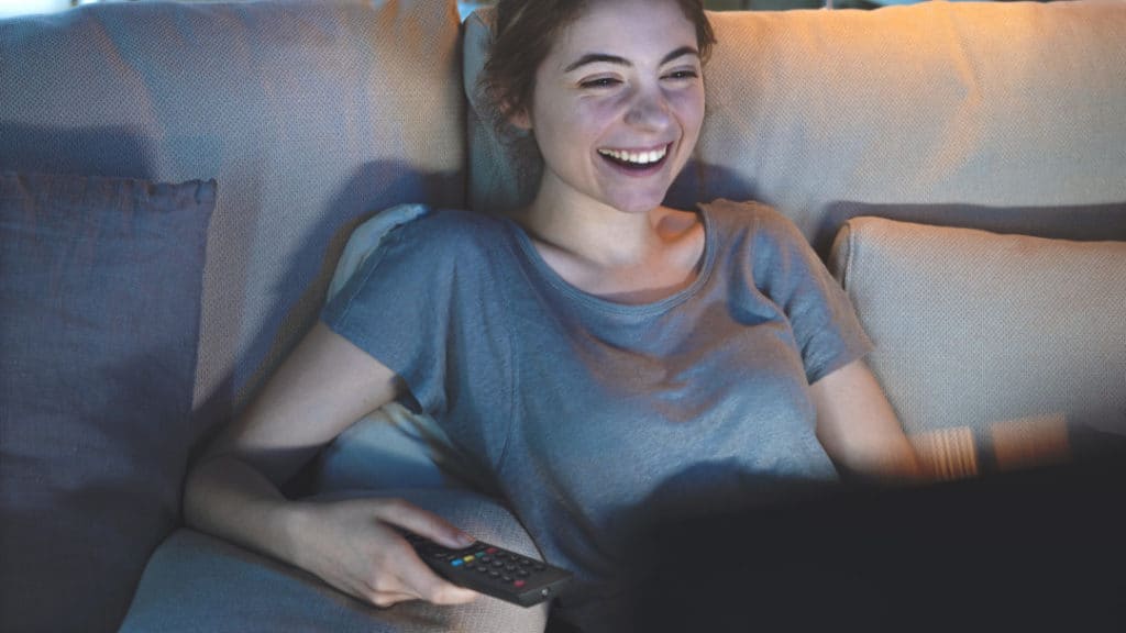 Young girl watching tv at home