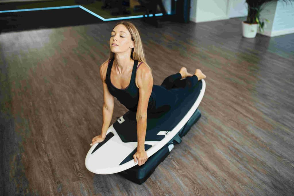 Women doing yoga on a surfboard
