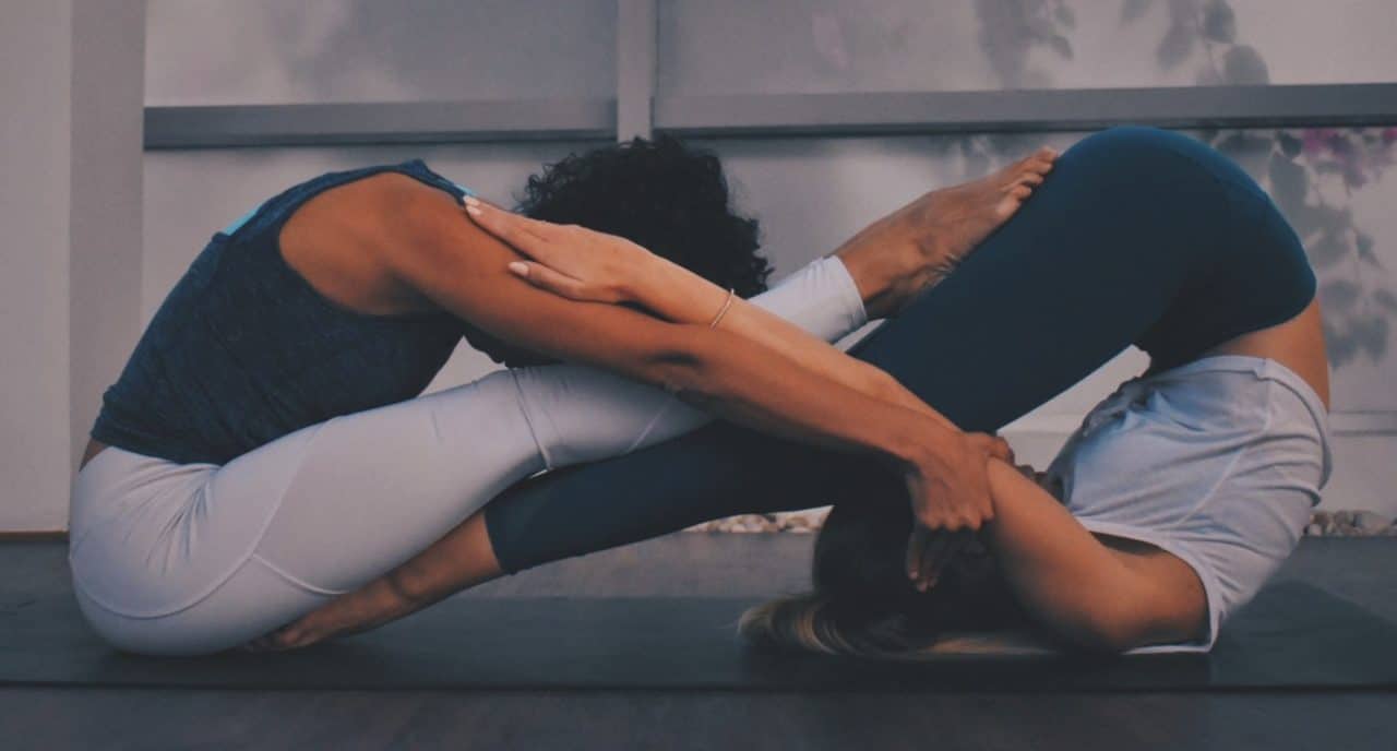 Two women doing yoga exercises excercises