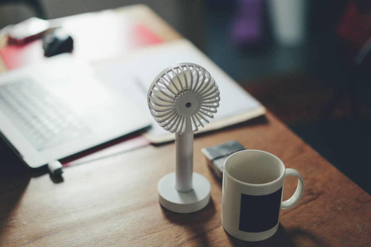 Electric fan on a desk working remotely