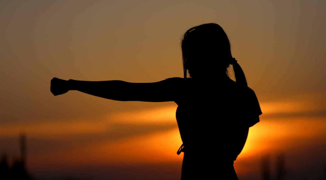 Women is boxing at sunset